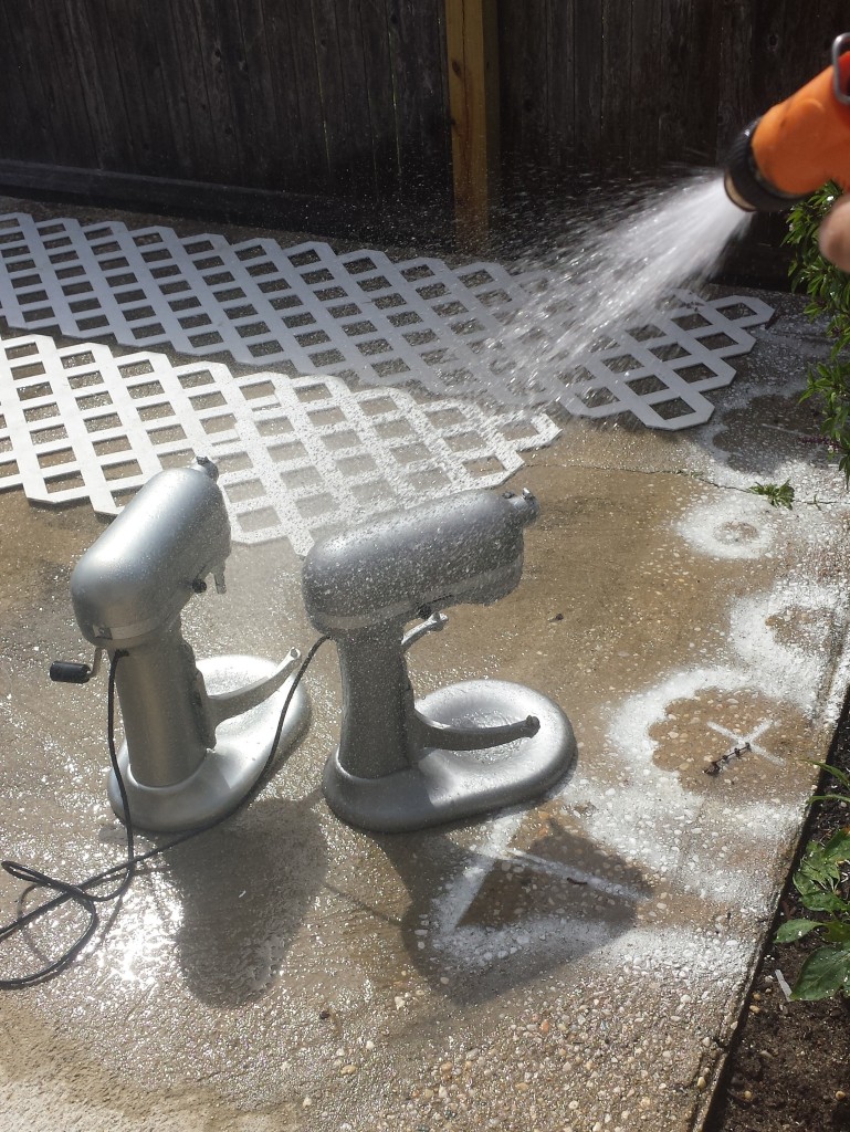 I'm hosing down the twins on the patio, right where I painted a cupcake stand white.